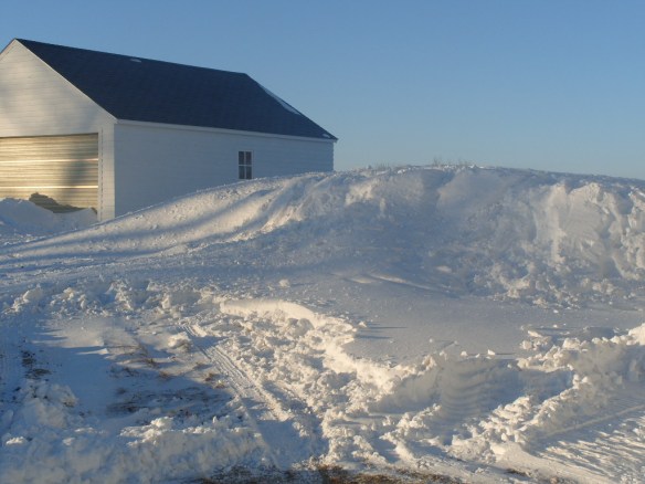 You would think that a building would provide protection from snow, but it can actually collect more snow than an open area.