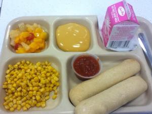 Random shot of an actual high school lunch tray. Can anyone name the major item missing from this tray? (And yes, milk, cheese and bread do contain a bit of this item, so don't get too technical on me.) And by the way, the elementary students only received one breadstick. Lower calorie limits, you know.